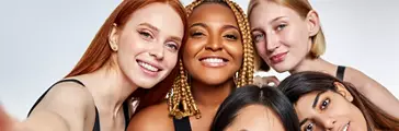Group of female models sitting close smiling